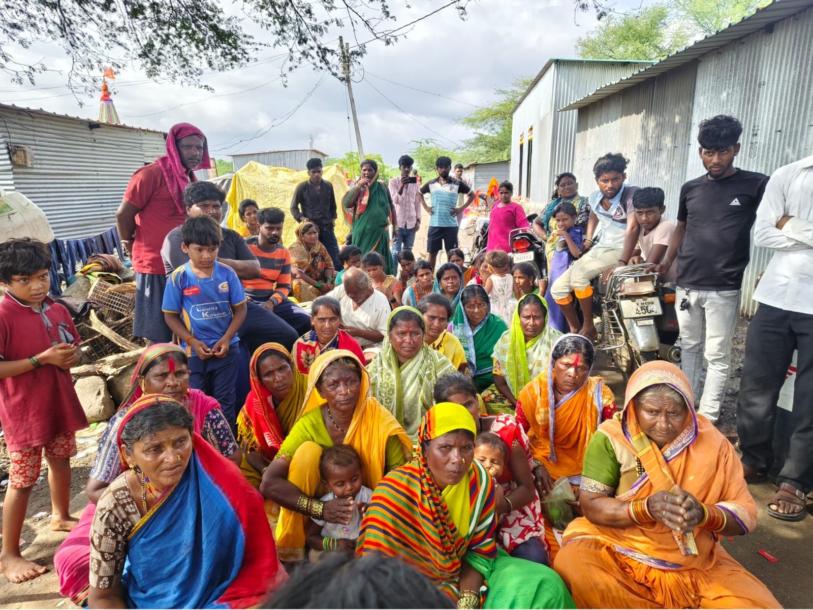 Our team listening to families during a village meeting